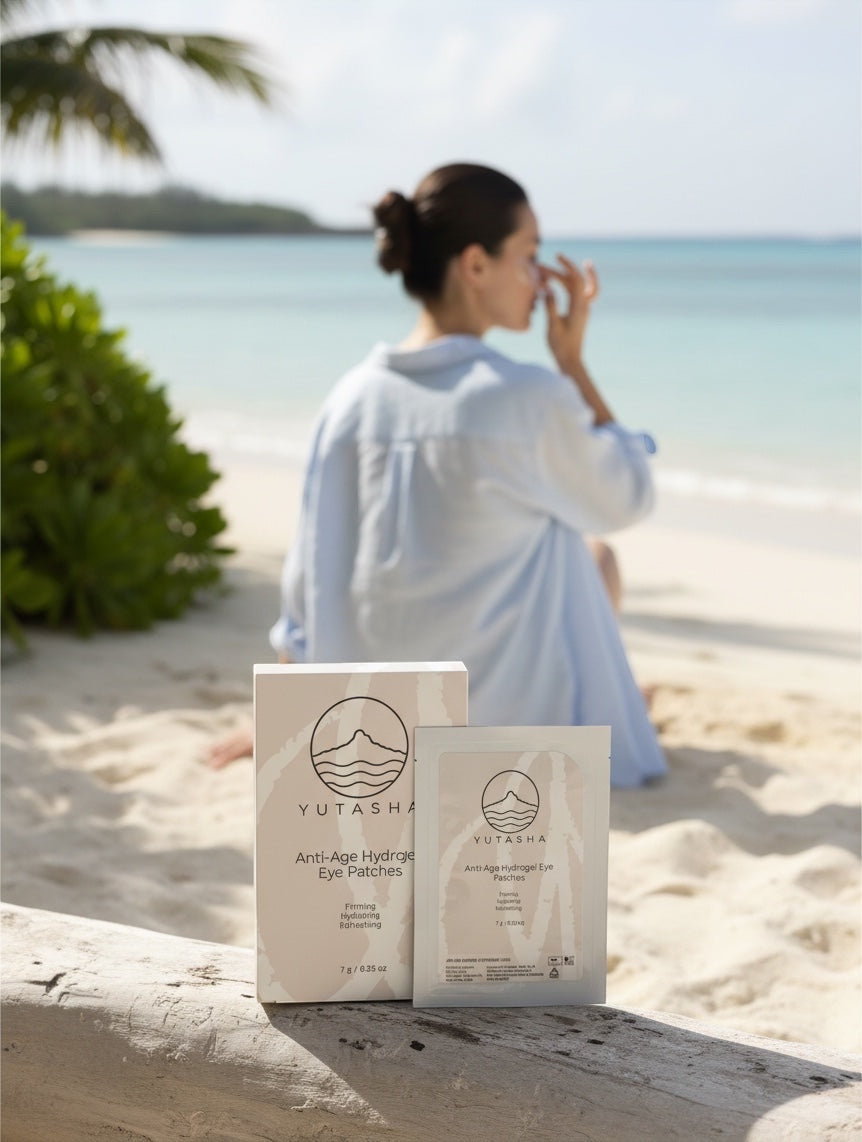 YUTASHA Anti-Age Hydrogel Eye Patches packaging on a beach with a woman applying skincare in the background.