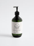 YUTASHA Natsu grapefruit hydrating body wash in a dark green bottle with a black pump dispenser on a white background.